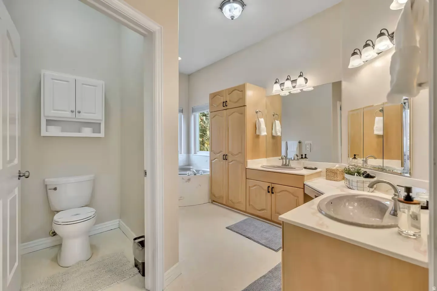 Bathroom with two vanities and toilet