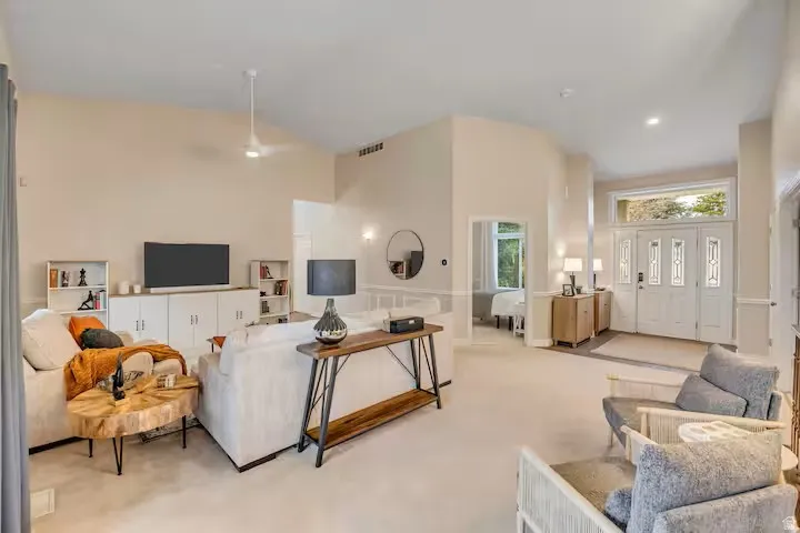 Living room featuring light carpet and lofted ceiling
