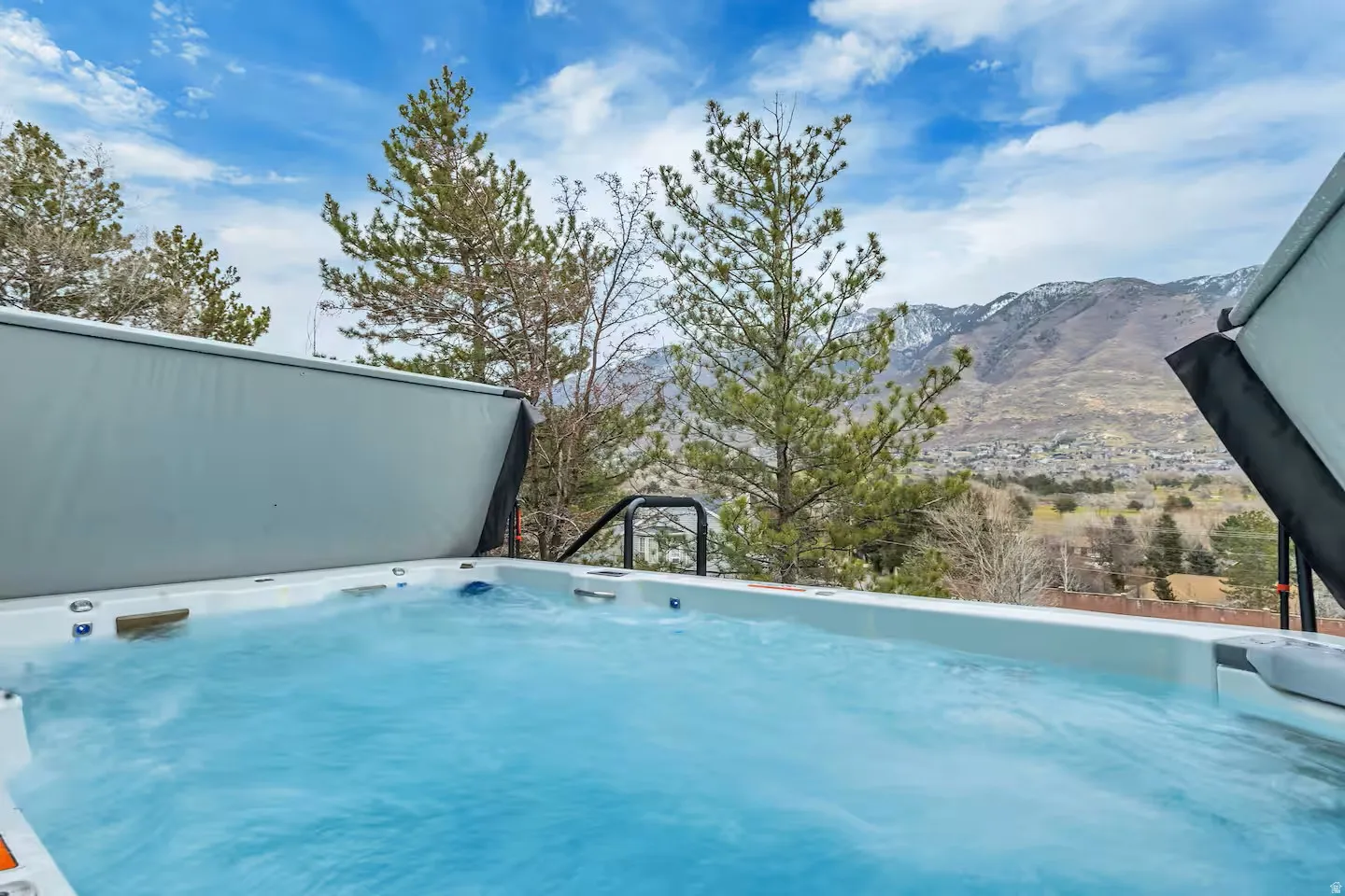 View of swimming pool featuring a mountain view and a hot tub
