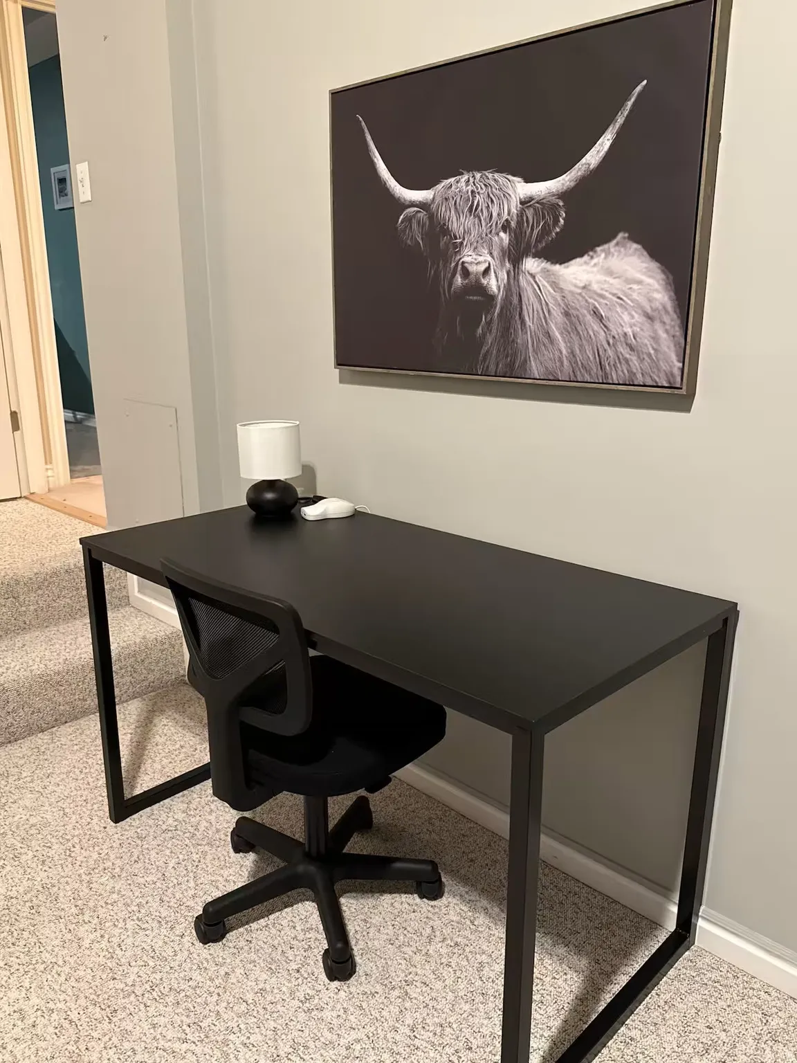 Office space with light colored carpet and baseboards