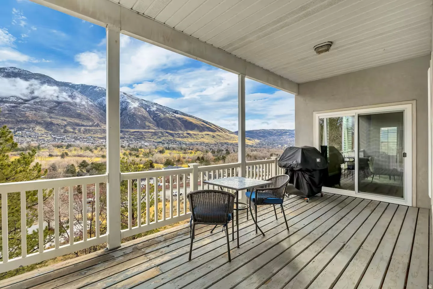 Deck featuring a mountain view, area for grilling, and outdoor dining area
