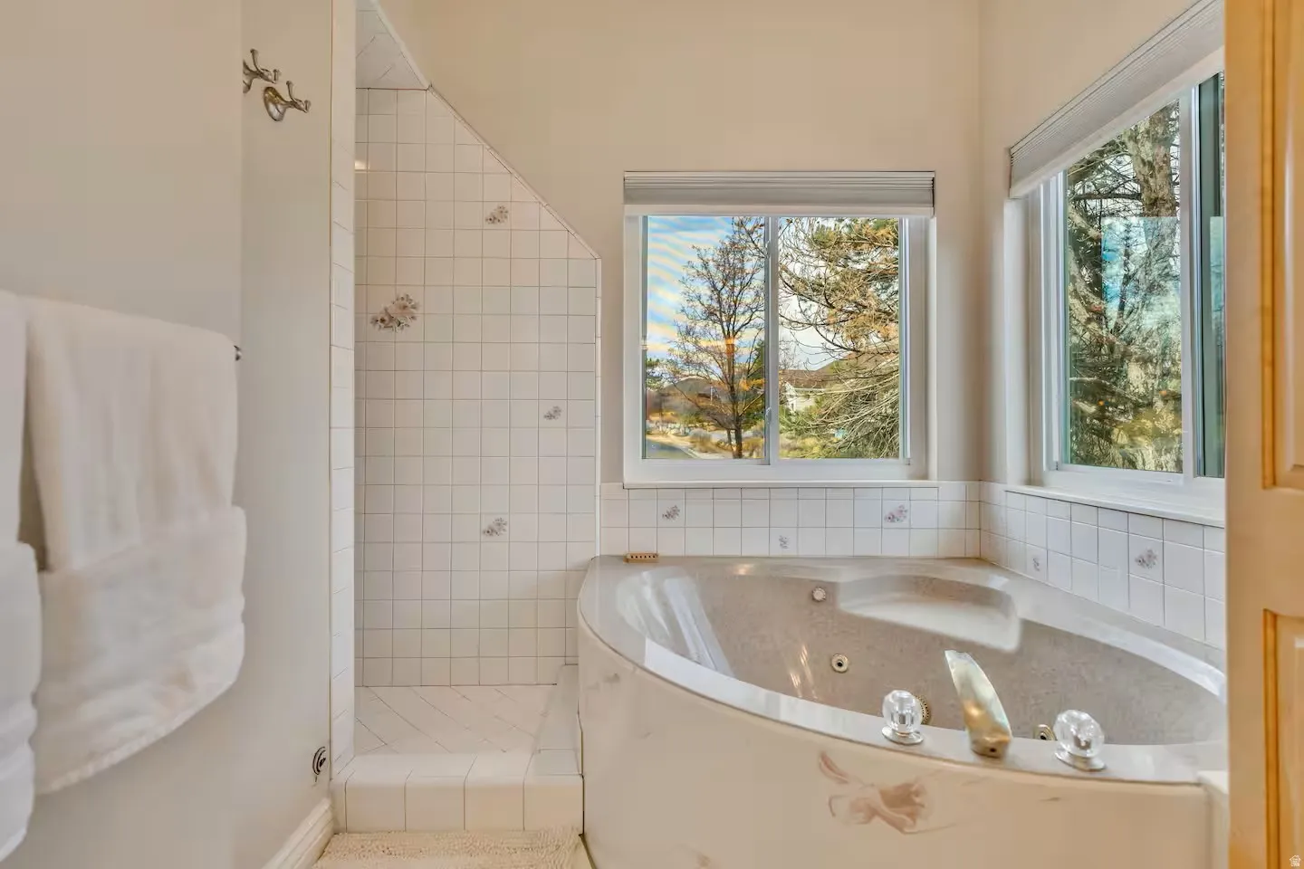 Bathroom featuring a stall shower and a jetted tub