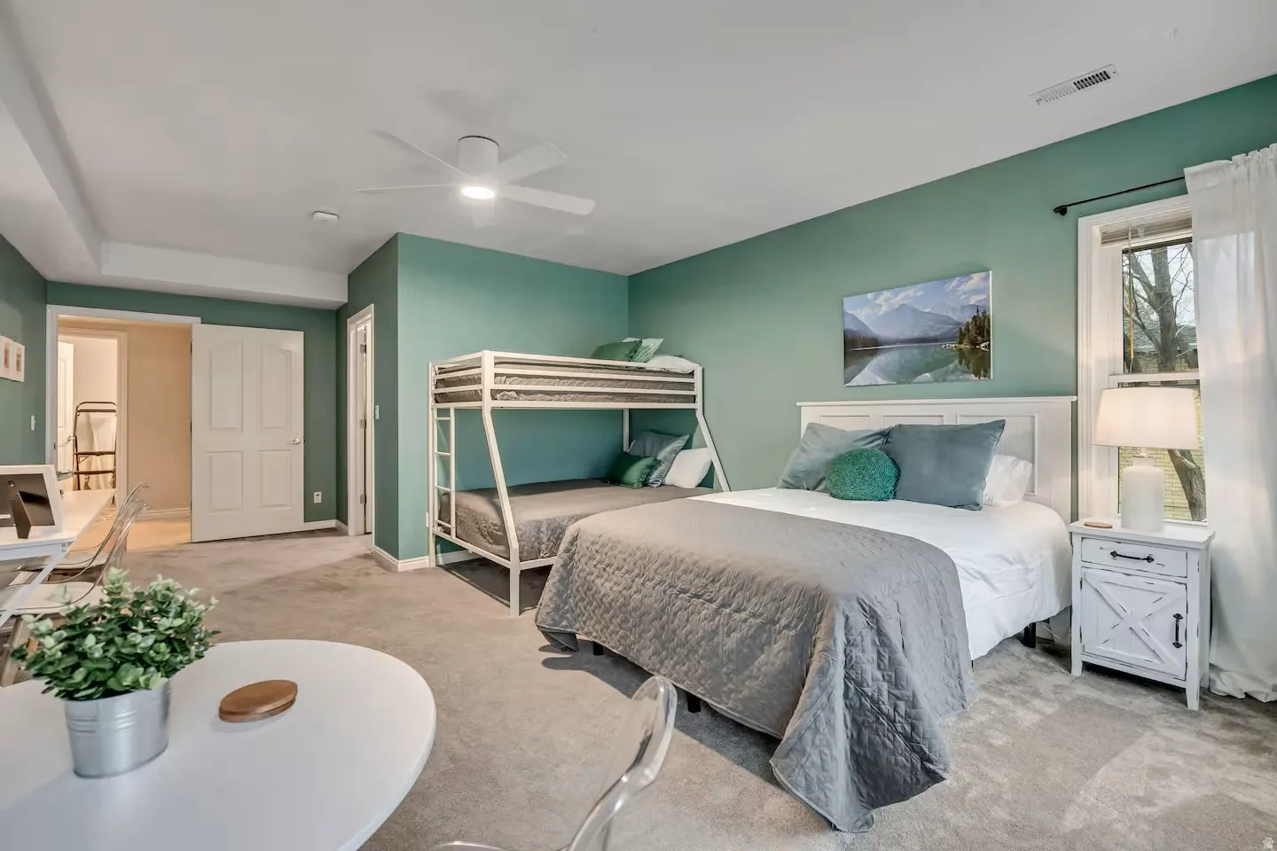Bedroom featuring light carpet and a ceiling fan
