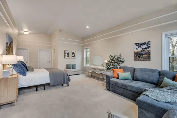 Carpeted bedroom with lofted ceiling and recessed lighting