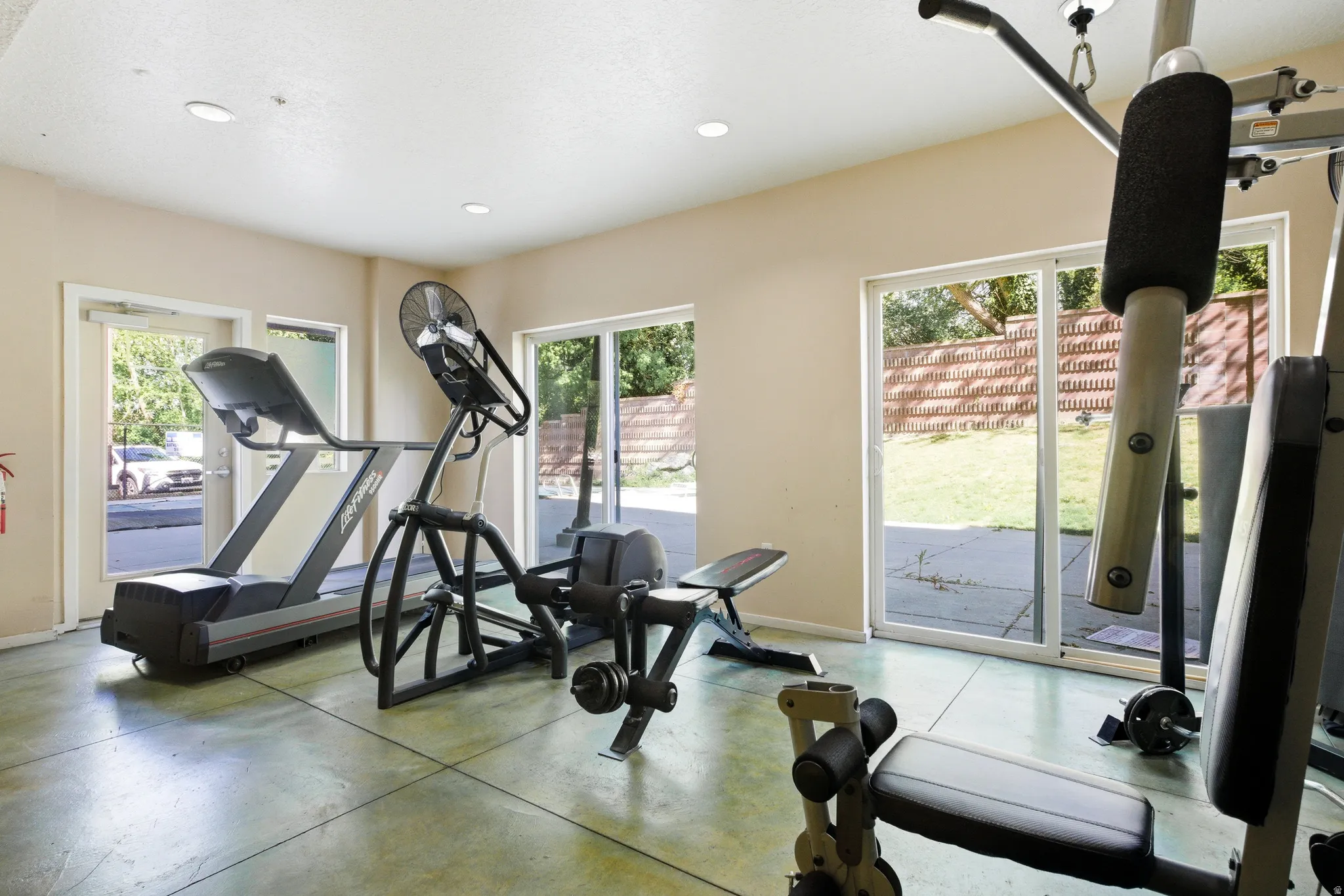 Exercise area with concrete flooring and recessed lighting
