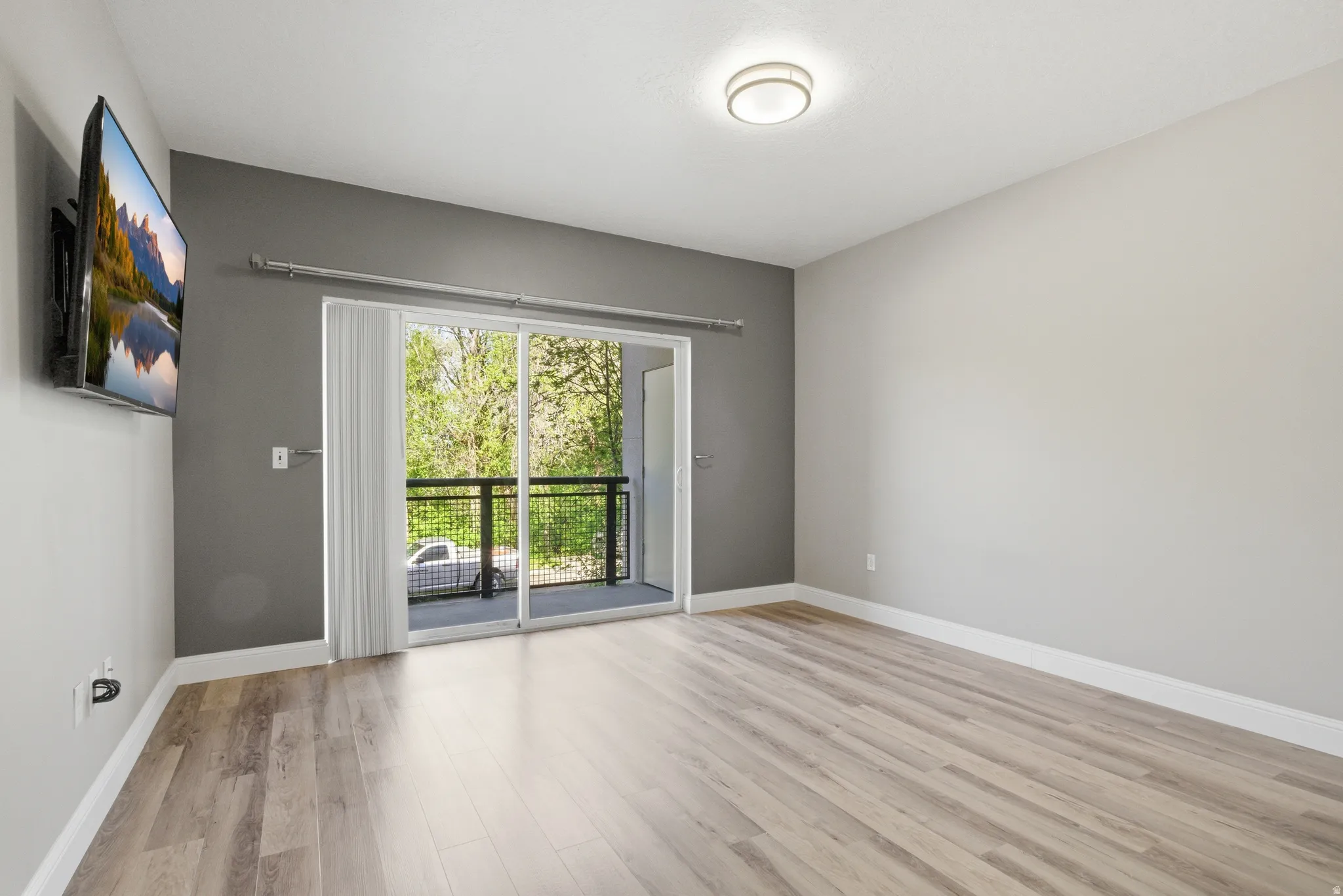Living room with light wood-type flooring and baseboards