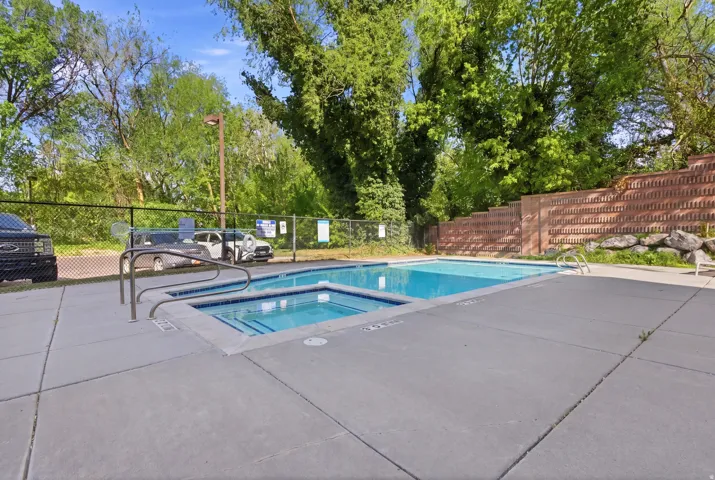Community pool featuring a patio area and a community hot tub