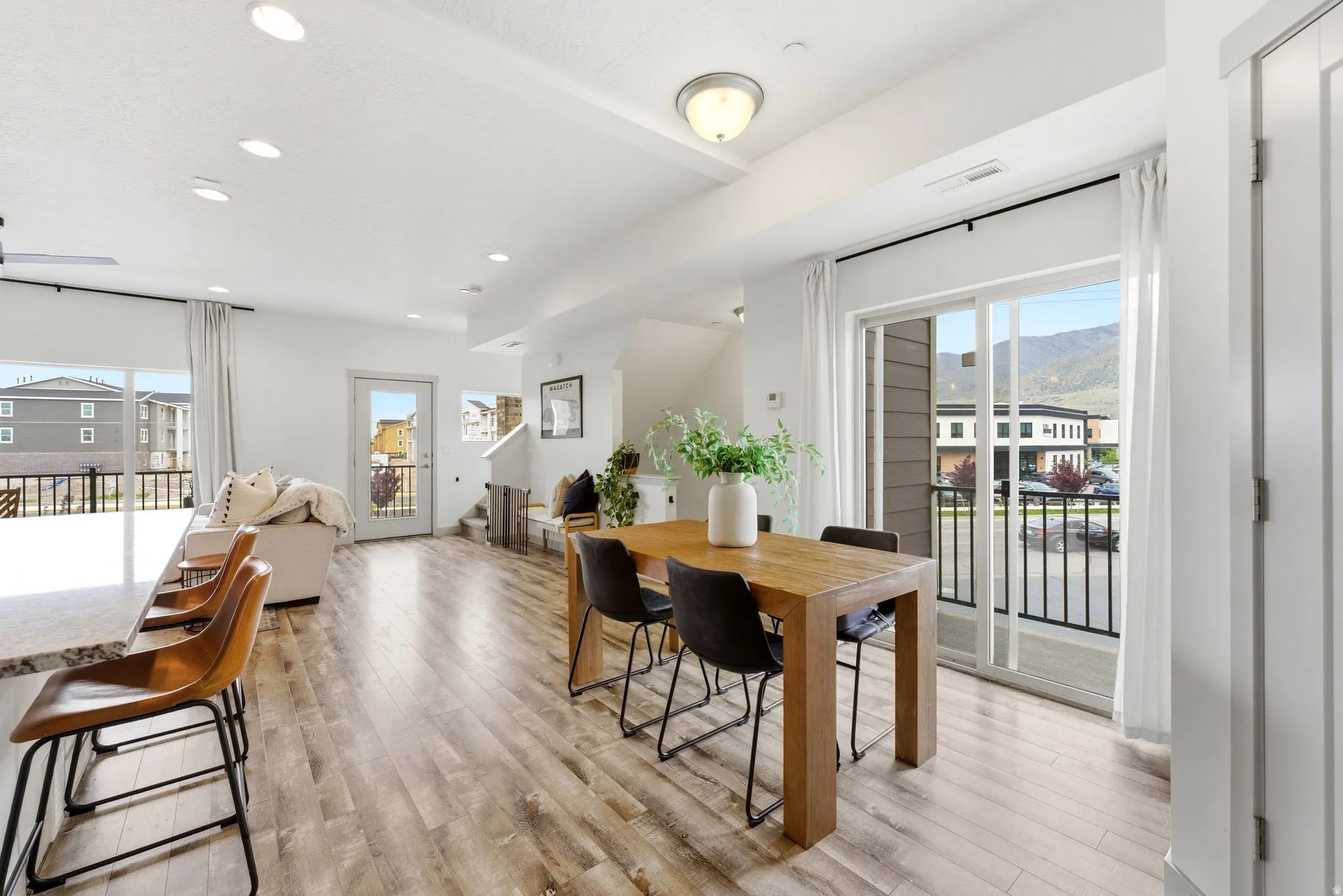 Dining area featuring plenty of natural light, light wood-style floors, recessed lighting, and a mountain view
