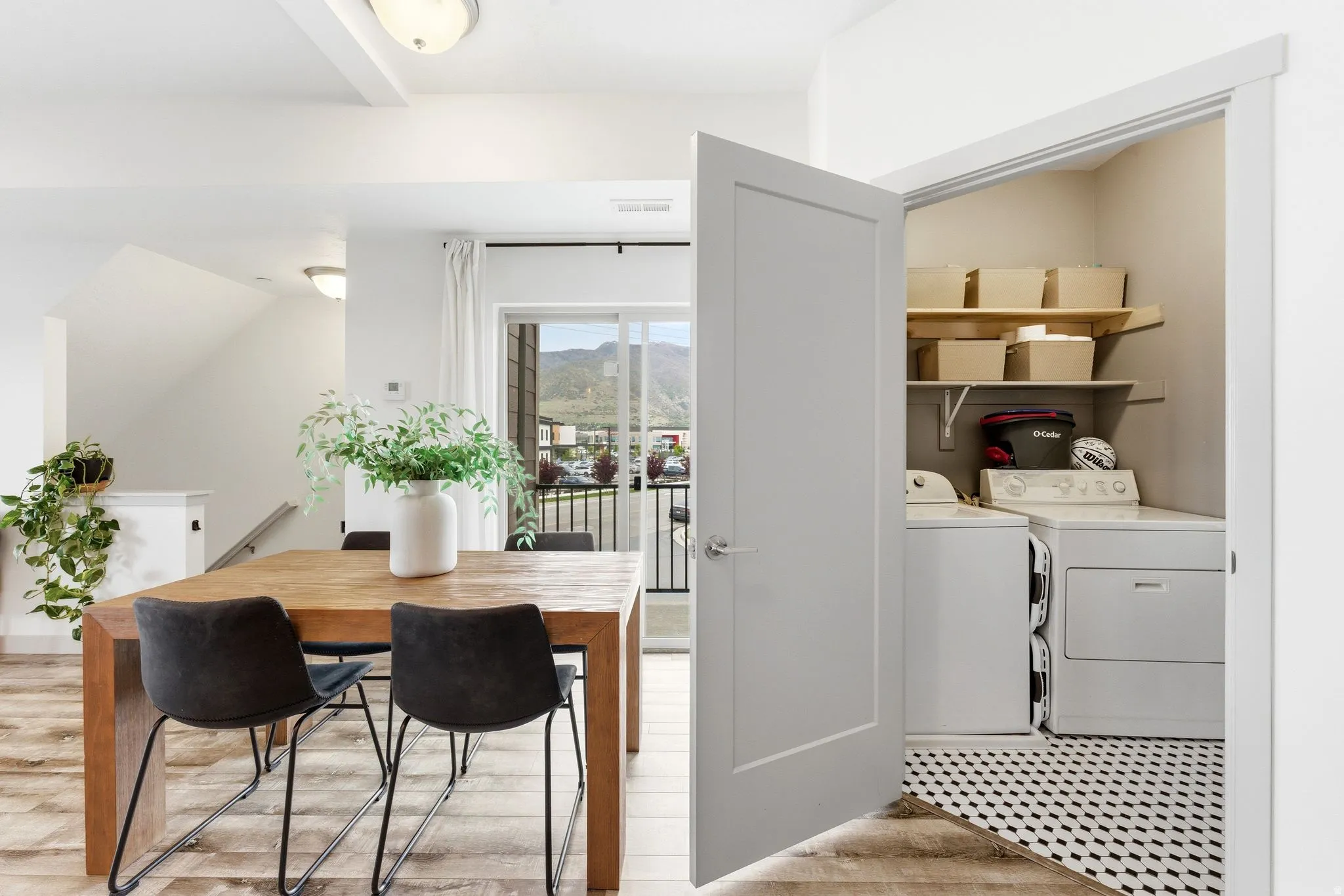 Laundry area featuring independent washer and dryer, light wood-type flooring, and vaulted ceiling