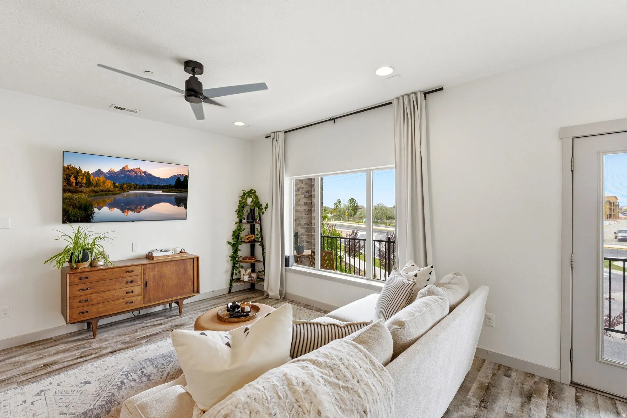 Living room featuring a ceiling fan, light wood finished floors, and recessed lighting