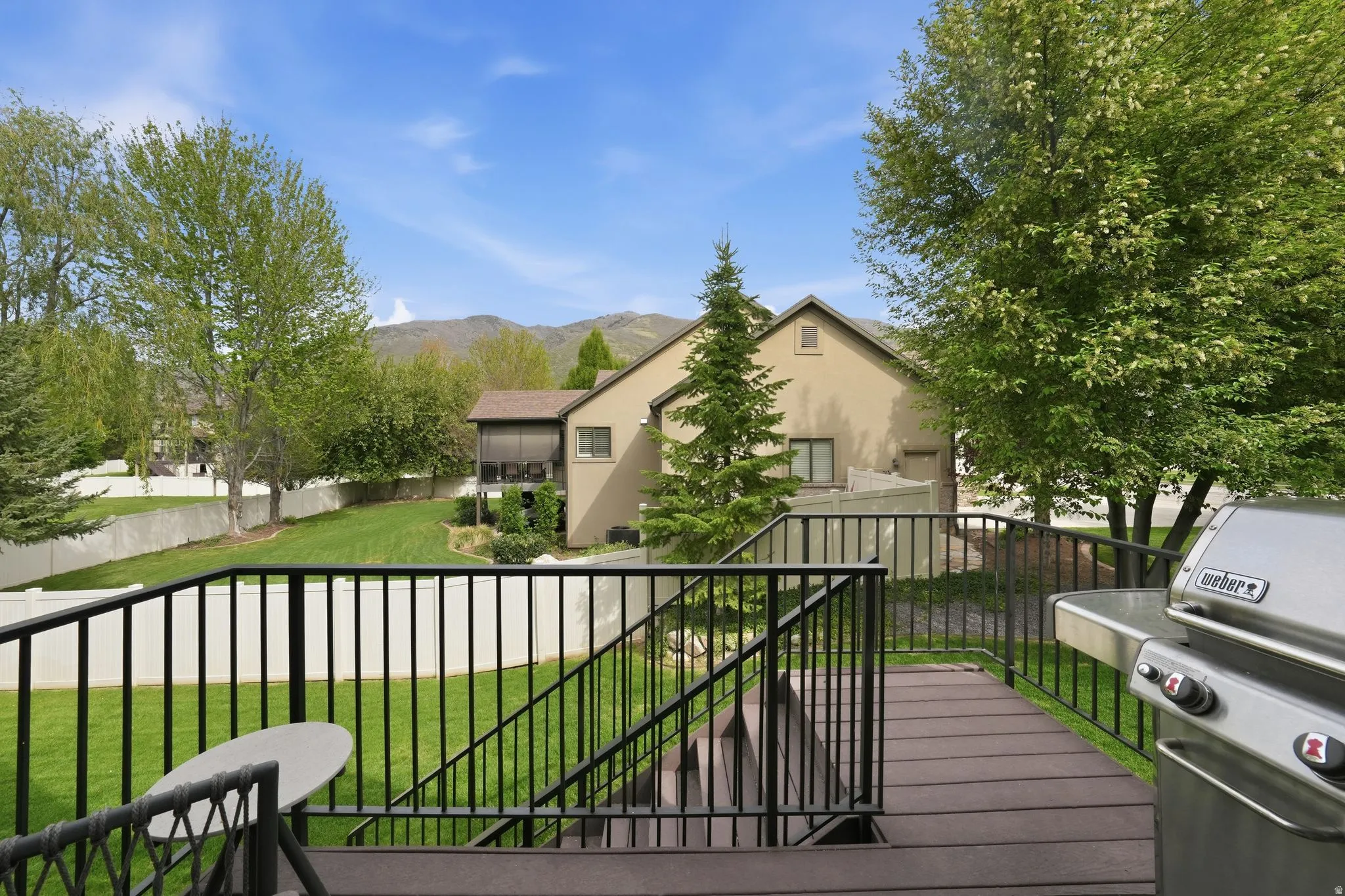 Wooden deck with grilling area and a mountain view