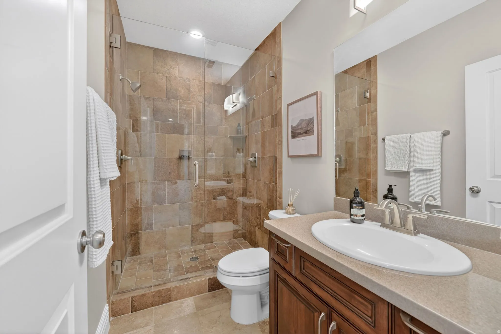 Bathroom with vanity and a shower stall