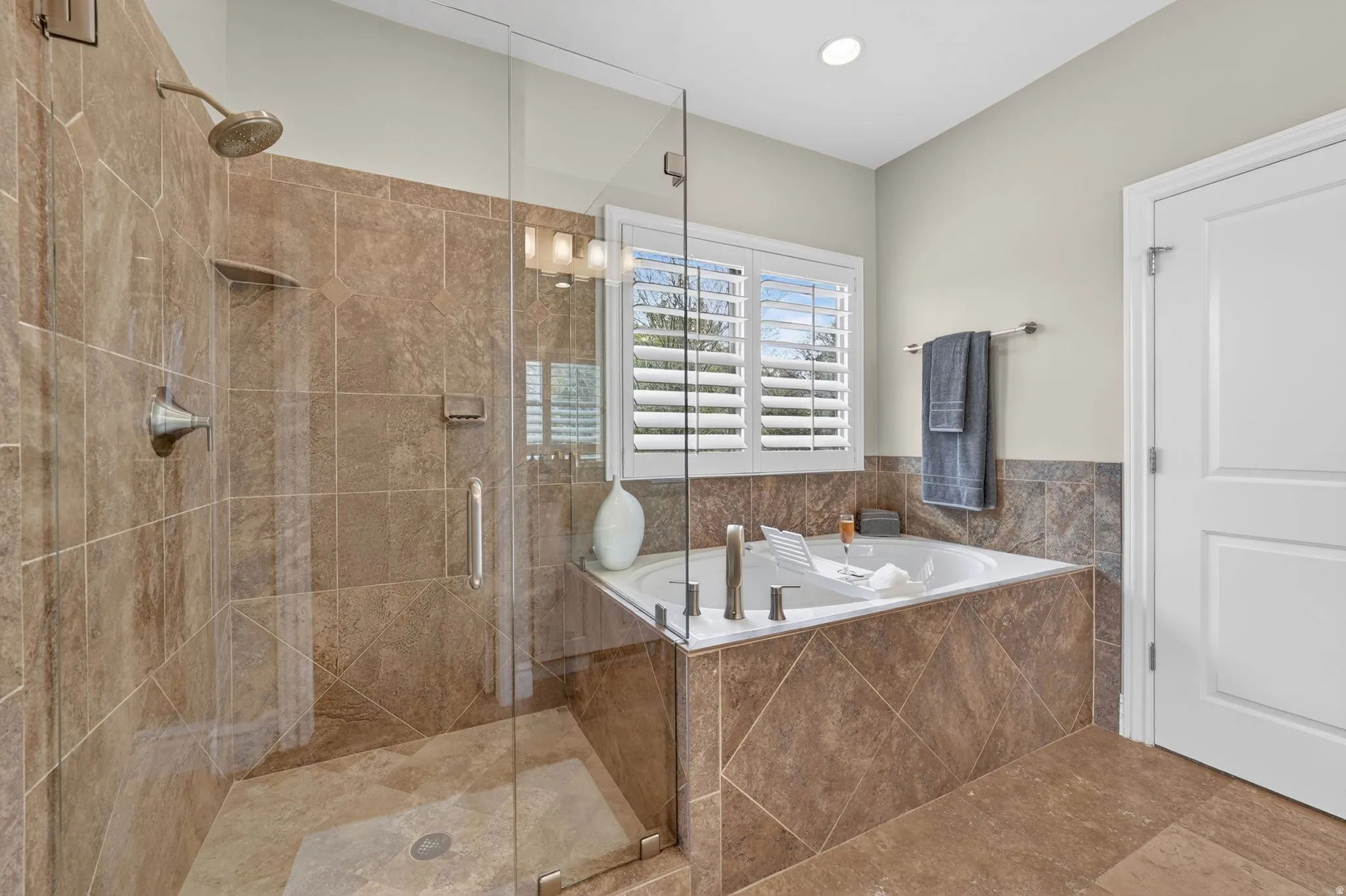 Full bath with a stall shower and a garden tub