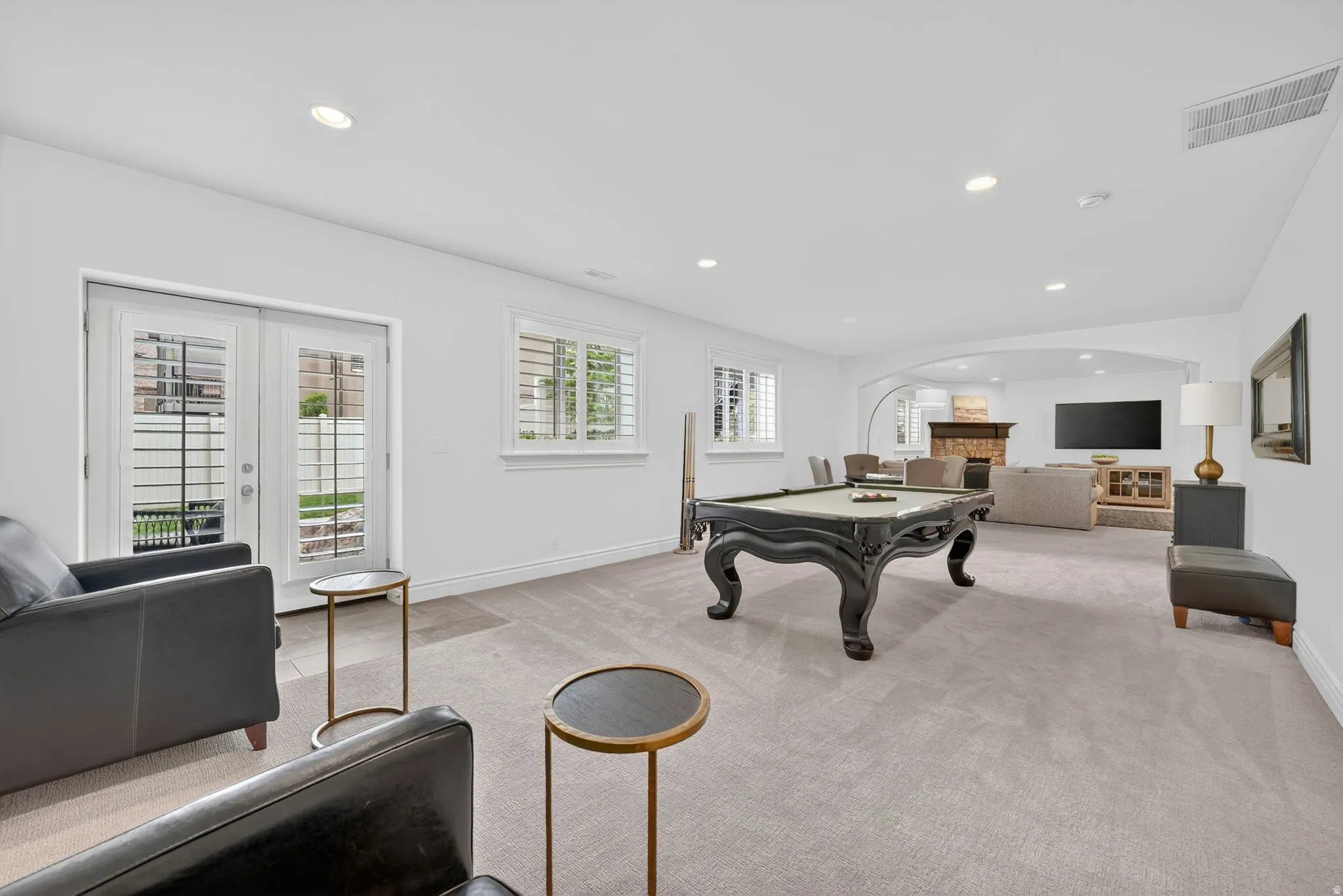 Rec room with recessed lighting, light colored carpet, billiards table, french doors, and a fireplace