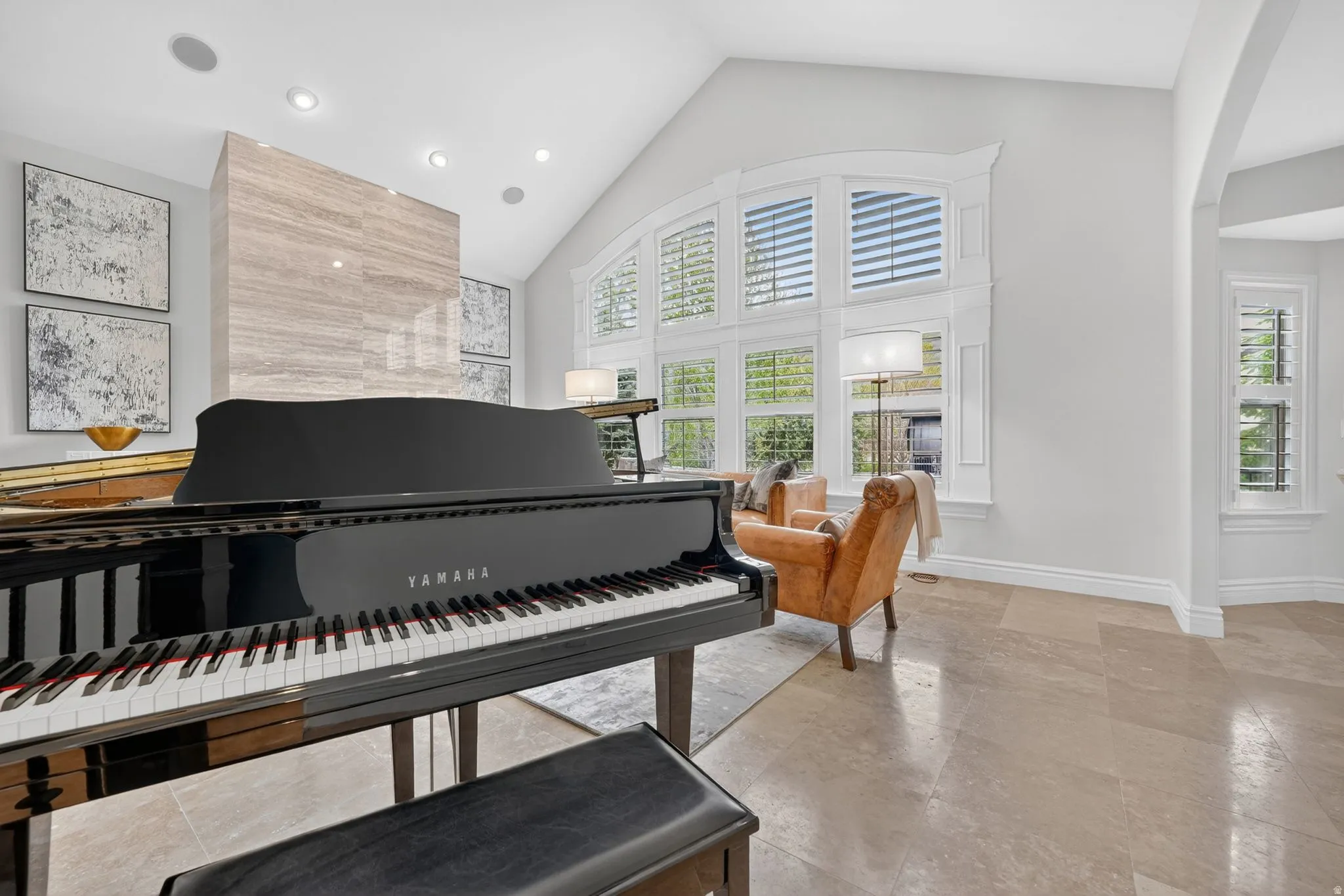 Living area featuring arched walkways, a high ceiling, and recessed lighting