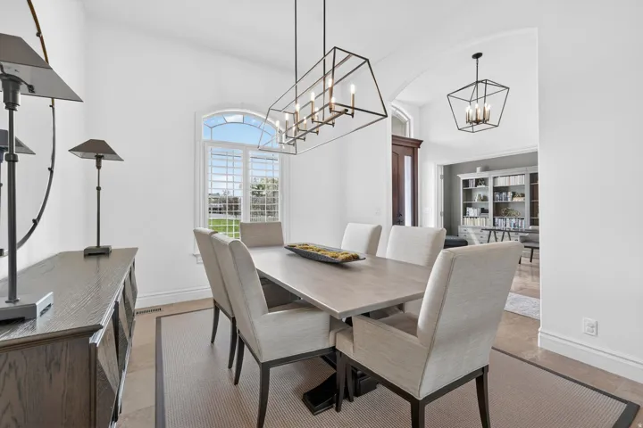 Dining room with a high ceiling and a chandelier