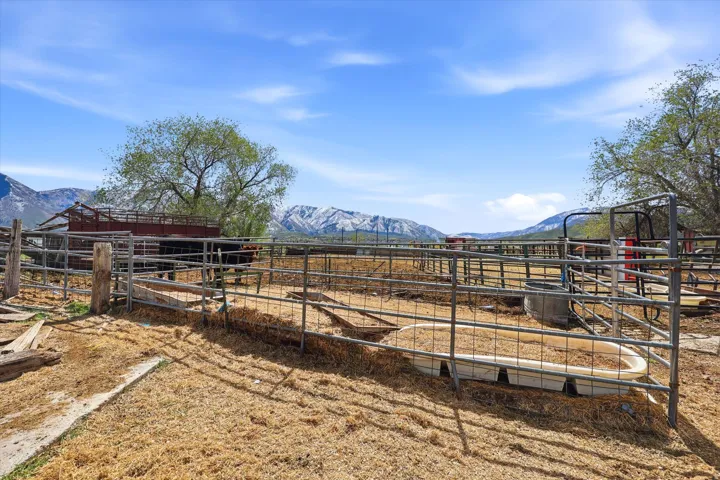 View of yard with a mountain view, an outdoor structure, and an exterior structure