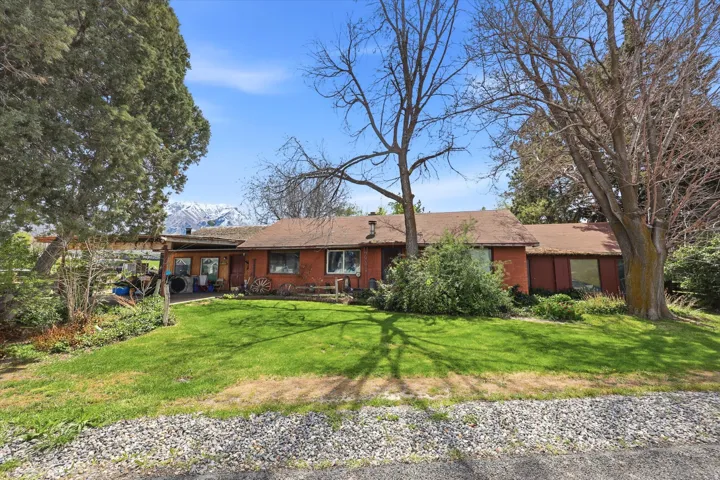 View of front of home featuring a front yard and brick siding