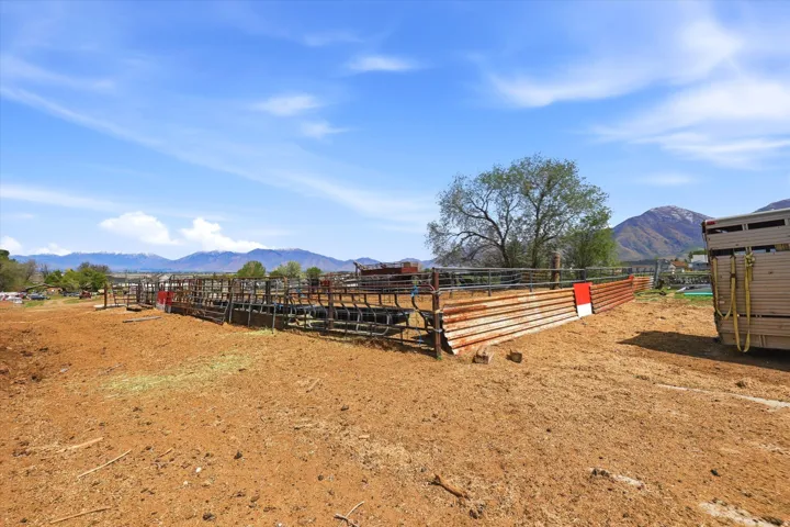 View of yard with a mountain view, an outdoor structure, and an exterior structure
