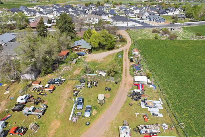 Aerial view of property and surrounding area with nearby suburban area