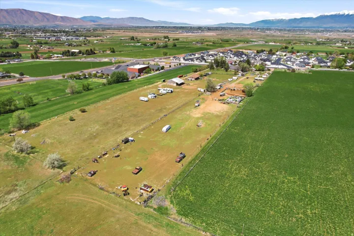 Aerial overview of property's location featuring a mountain backdrop and rural landscape