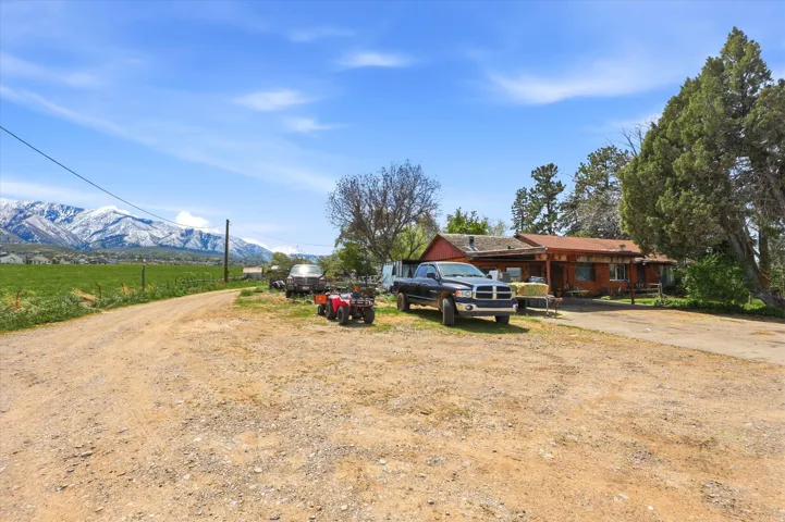 View of front of property with driveway and a mountain view