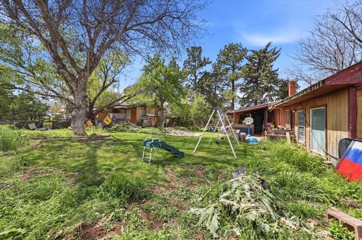 View of green lawn featuring a playground