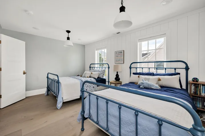 Bedroom featuring wood finished floors and baseboards