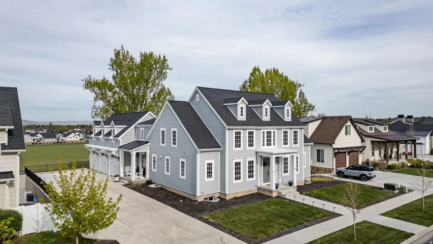 View of front of home with driveway, a residential view, a front yard, and a shingled roof