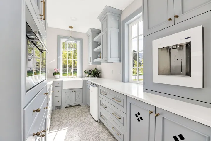 Bar area featuring pendant lighting, gray cabinetry, oven, open shelves, and plenty of natural light