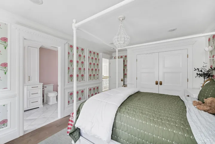 Bedroom with ornamental molding, a closet, and ensuite bath