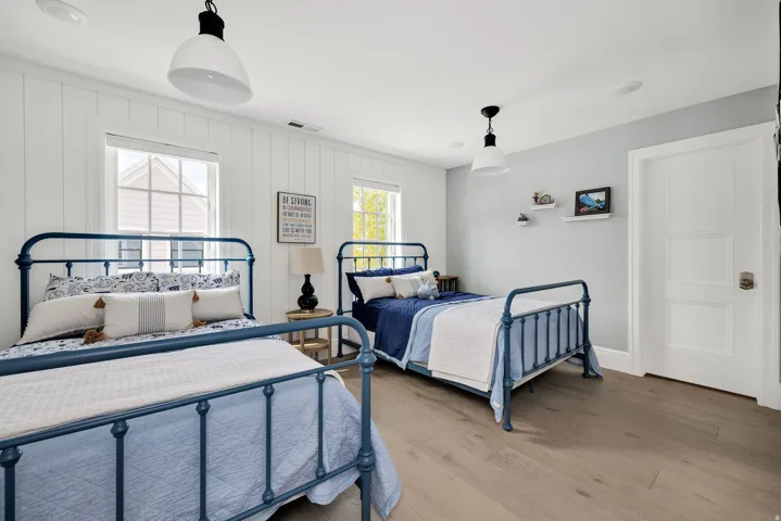 Bedroom featuring wood finished floors and baseboards