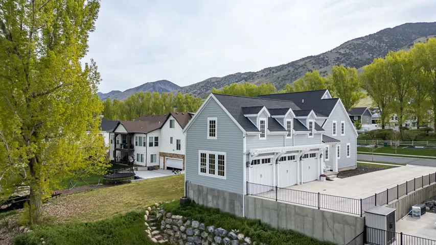 Rear view of property with a garage, a mountain view, and driveway