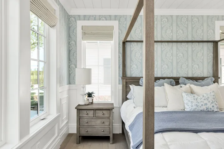 Bedroom with ornamental molding, a wainscoted wall, wallpapered walls, a decorative wall, and wood finished floors