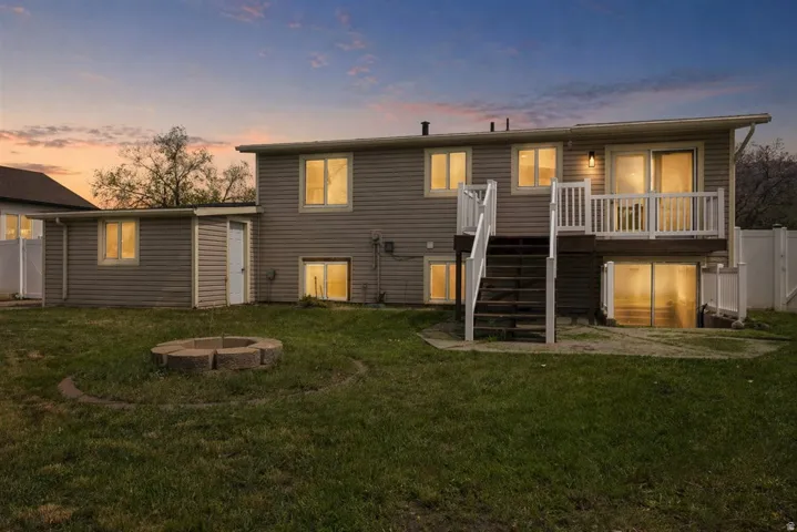 Rear view of house with a fire pit, a deck, and a patio area
