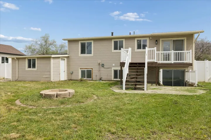 Rear view of property with an outdoor fire pit and a wooden deck