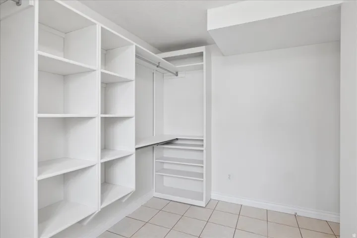 Walk in closet featuring light tile patterned floors