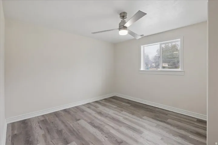 Spare room featuring light wood finished floors and ceiling fan