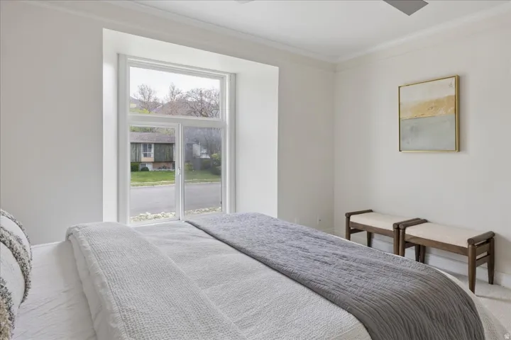 Bedroom with ornamental molding and baseboards