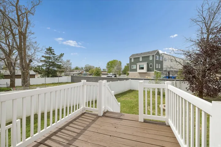 Deck with a fenced backyard and a residential view