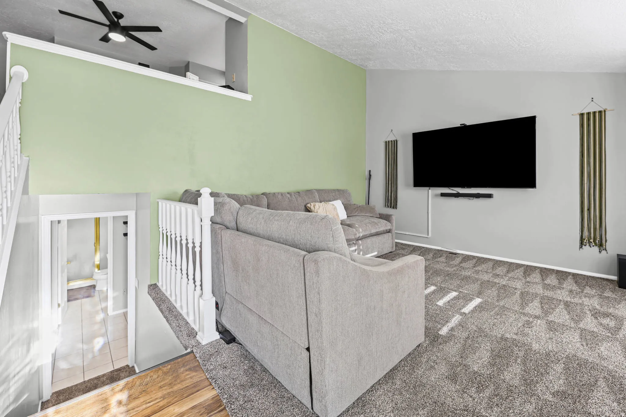 Living room with a ceiling fan and baseboards