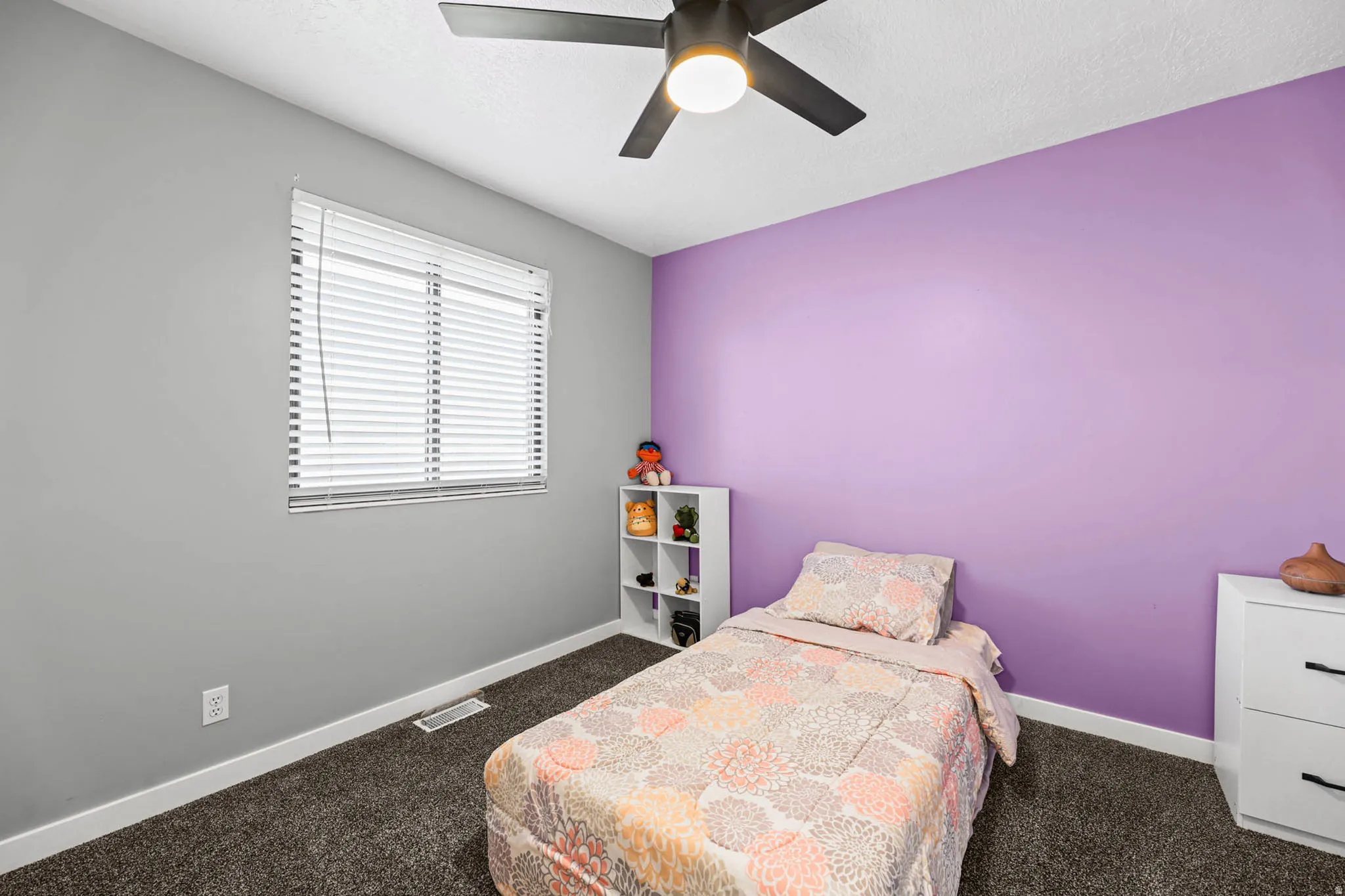 Bedroom featuring dark colored carpet and ceiling fan