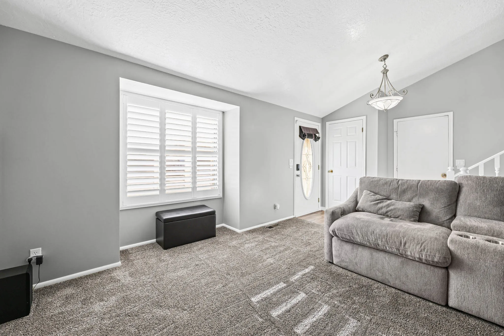 Living area featuring baseboards and carpet flooring