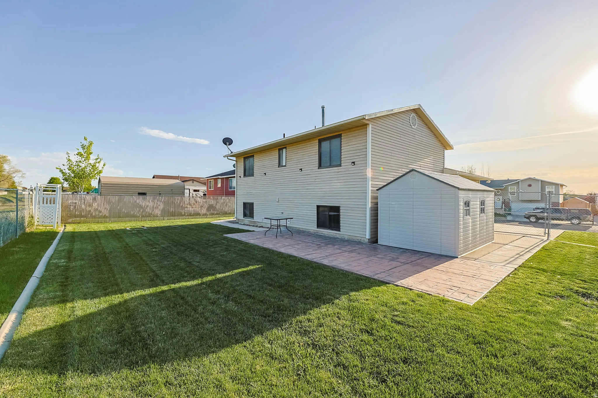 Rear view of house with a fenced backyard, a patio area, and a gate