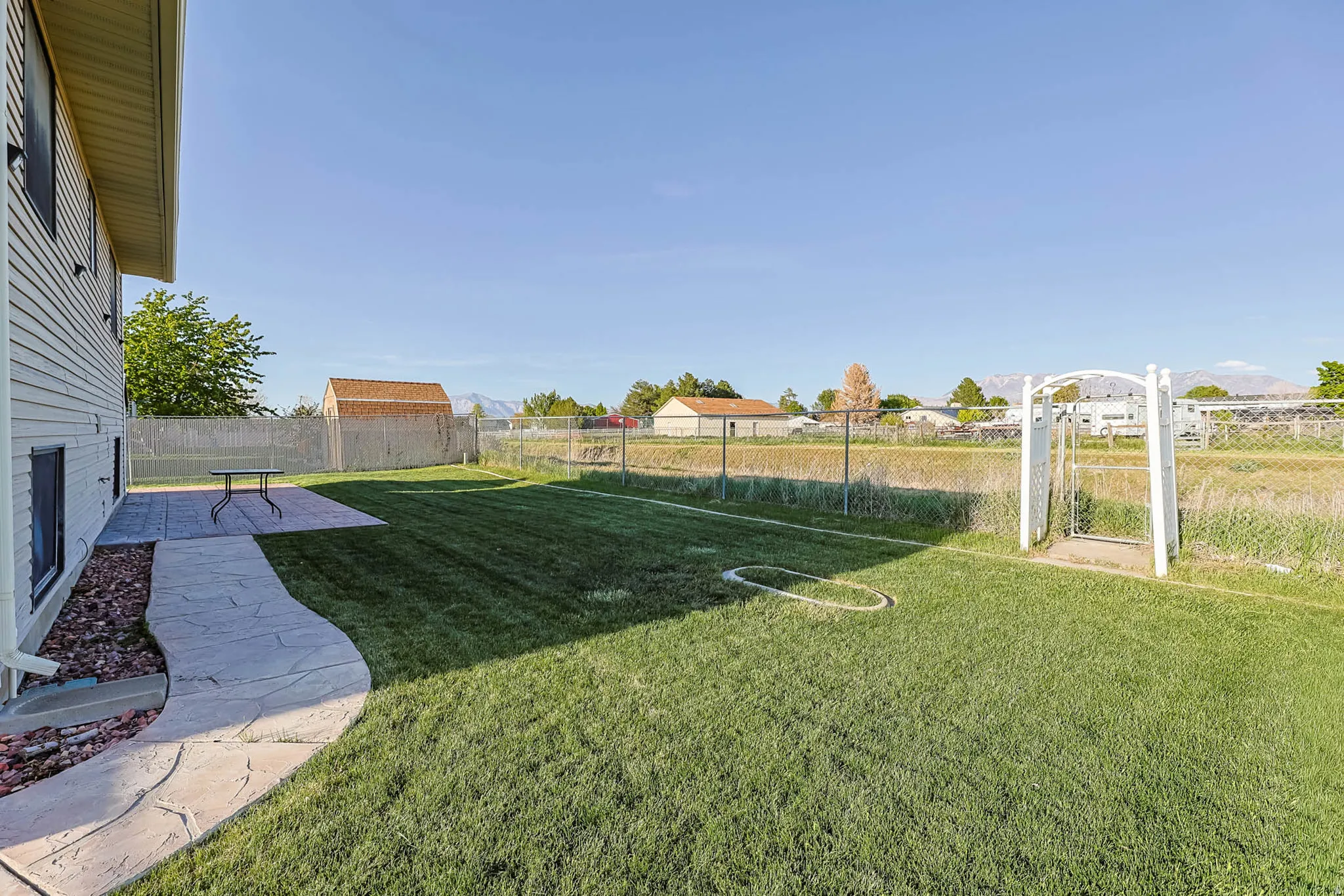 View of yard featuring a gate and a patio area