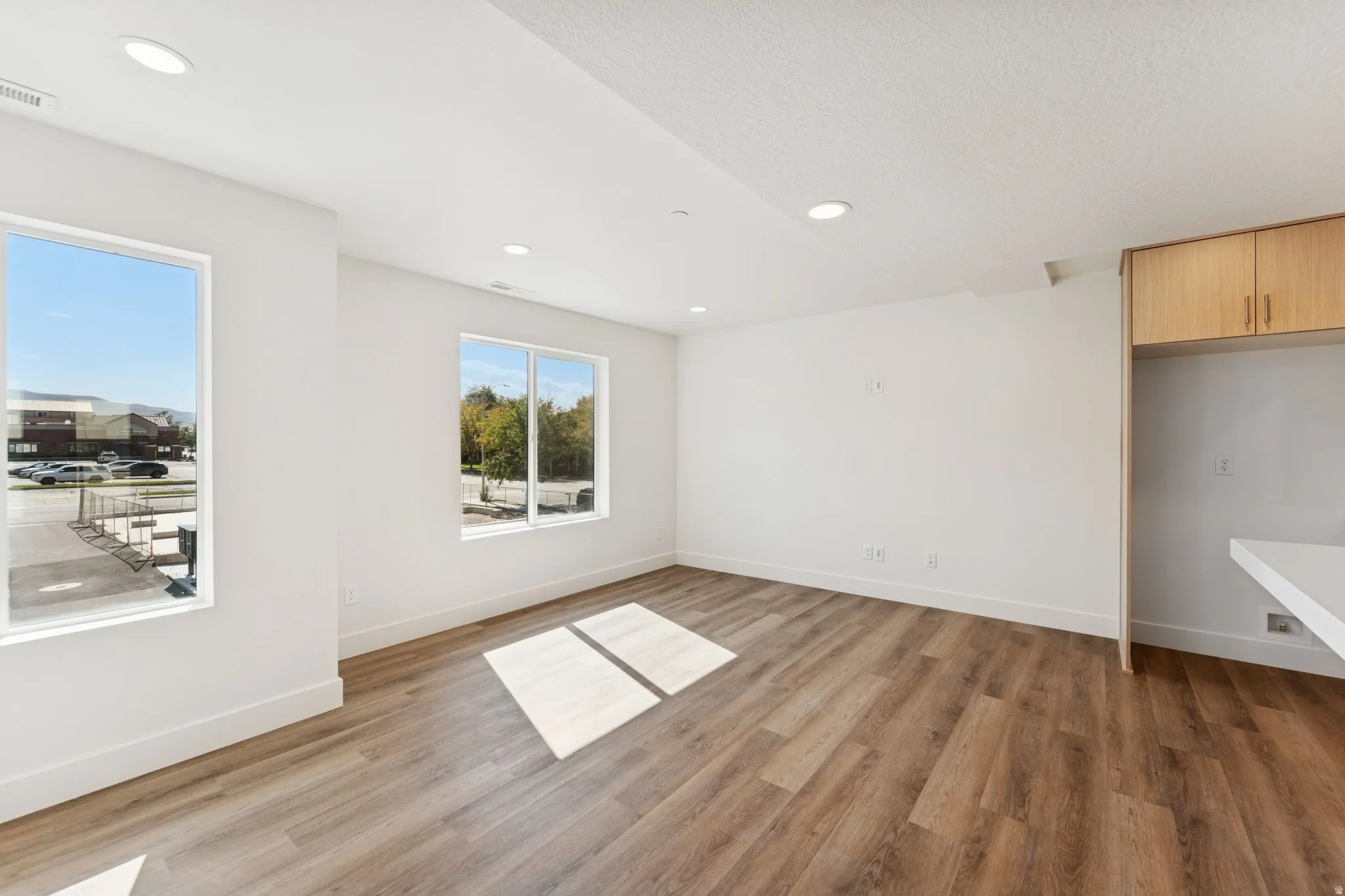Spare room featuring light wood-style flooring and recessed lighting