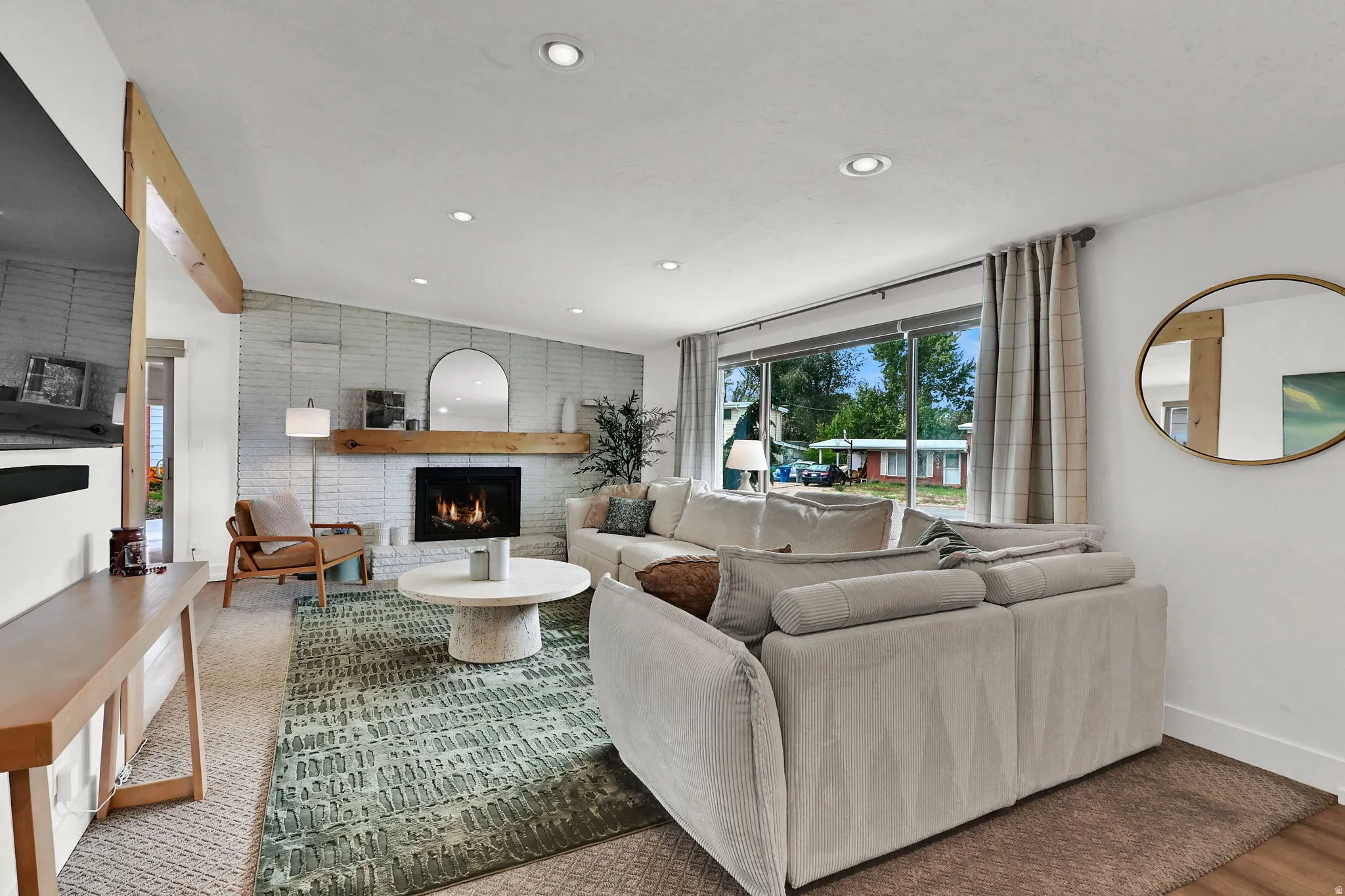 Living room with a fireplace and recessed lighting
