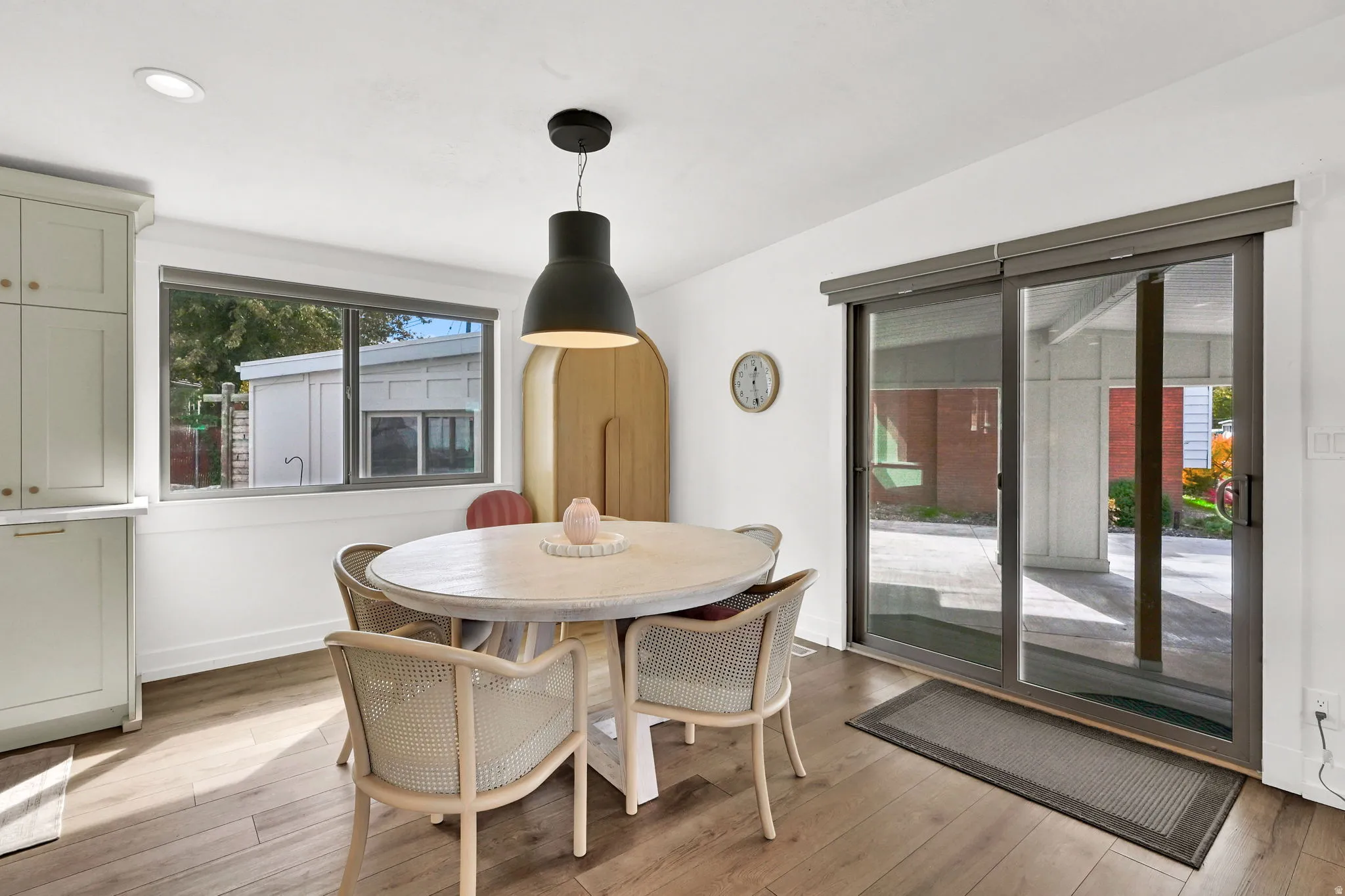 Dining area featuring light wood-style floors and baseboards