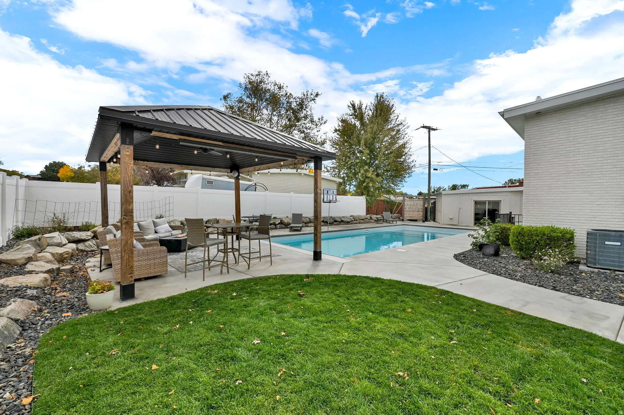 View of swimming pool featuring an outdoor hangout area, a patio, a fenced backyard, and a gazebo