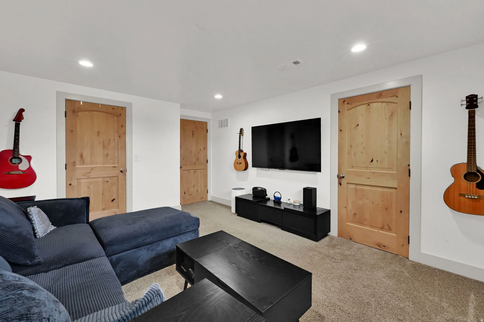 Living area with recessed lighting and carpet floors